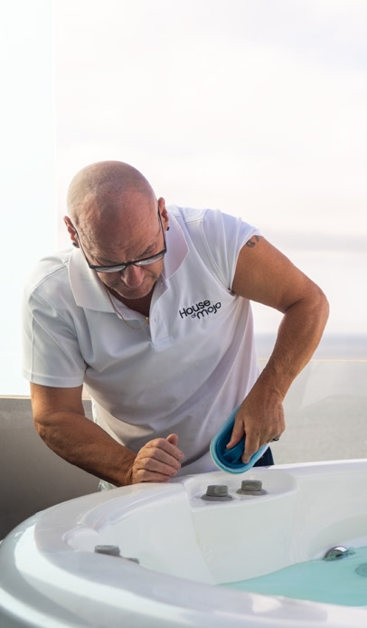House of Mojo maintenance technician cleaning a jacuzzi on a Costa del Sol property terrace