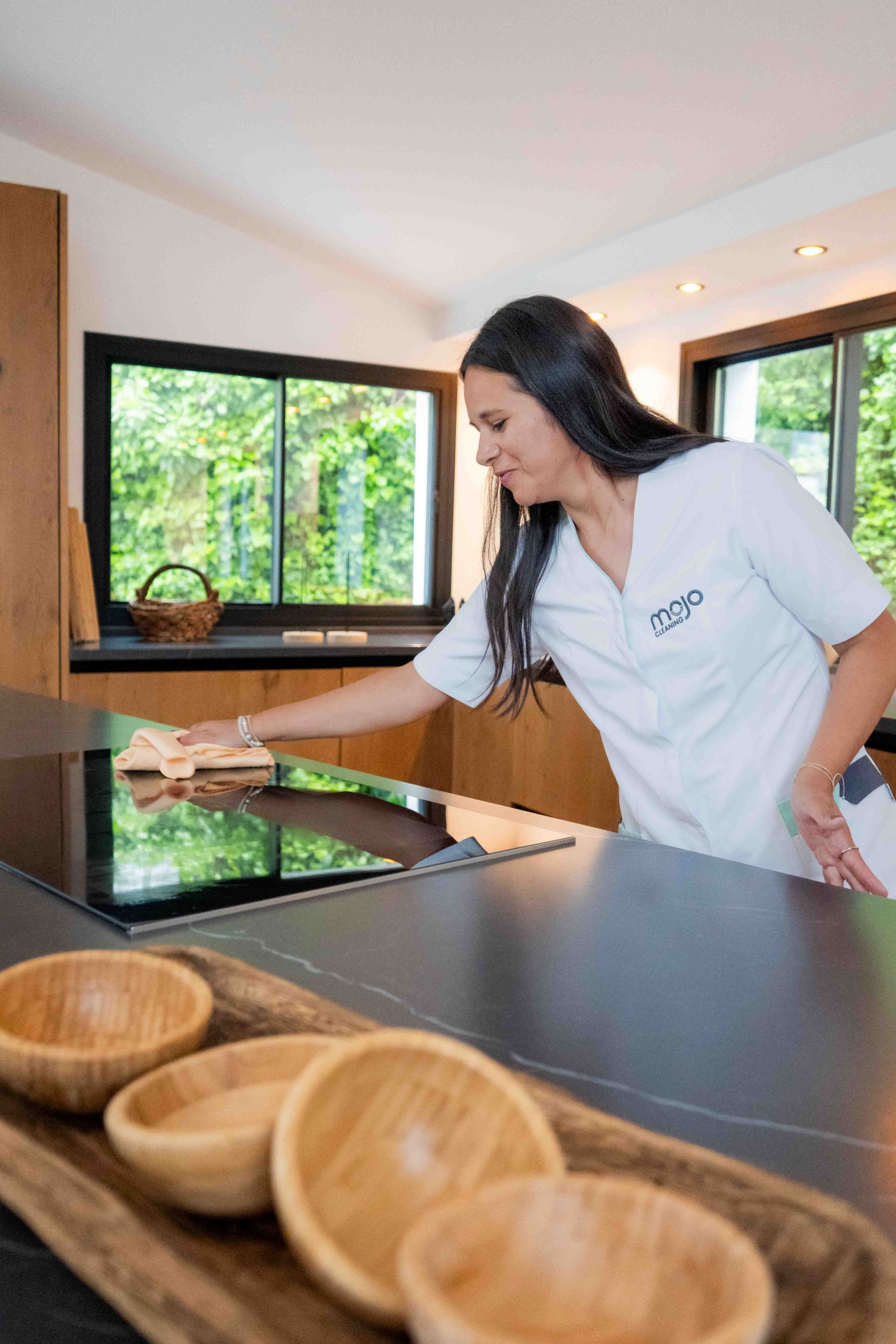 House of Mojo cleaning team member wiping a kitchen hob in a Costa del Sol property